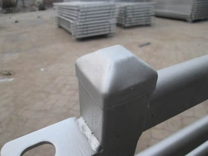 A piece of cattle corral fence with rain cap.