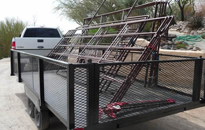 Pieces of steel corral panels are bundled and put on the trailer for traveling