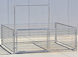 A small welded wire horse corral with gate